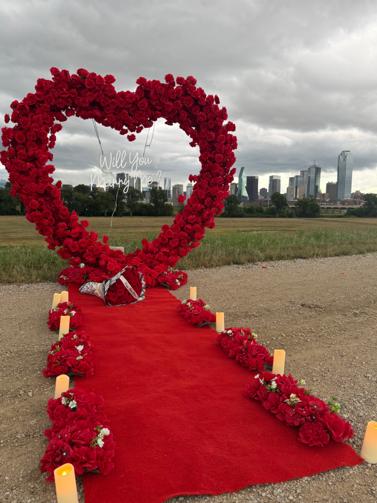 Red rose heart proposal setup overlooking the Dallas skyline
